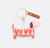 Dog-shaped keychain with heart pattern on a white background
