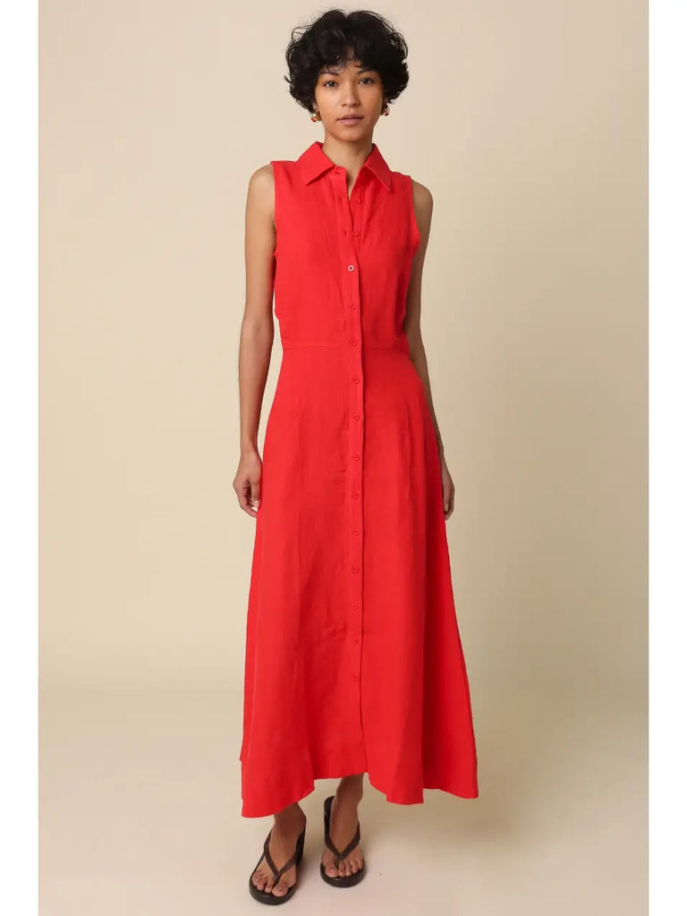 Woman wearing a red sleeveless dress against a beige background