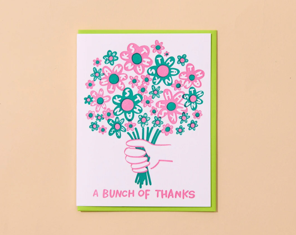 Card with a illustration of a hand holding flowers and text 'A Bunch of Thanks' on a beige background