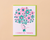 Card with a illustration of a hand holding flowers and text 'A Bunch of Thanks' on a beige background