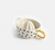 White ceramic citrus press with black polka dots and a yellow handle on a white background