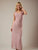 Woman wearing a pink dress against a plain background